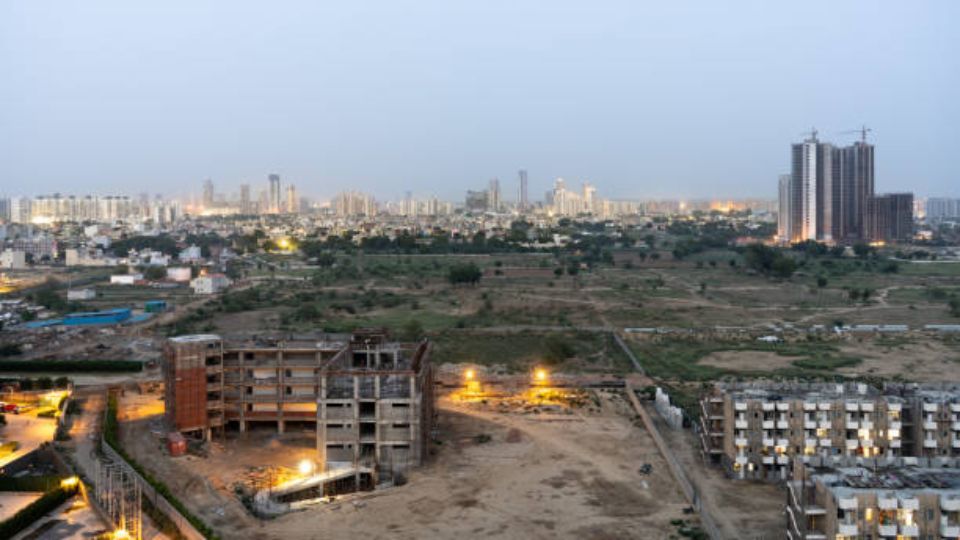 Aerial view of Gurugram construction site showing ongoing building development.